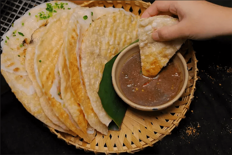Banh dap consists of two layers of crispy grilled rice paper, sandwiched between a layer of soft rice flour cake