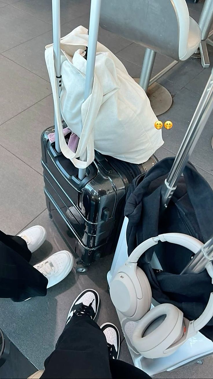 Traveler preparing luggage, headphones, and a light jacket before boarding an overnight sleeper bus.